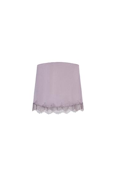 Front view of a lilac top with a lace trim on the hem.