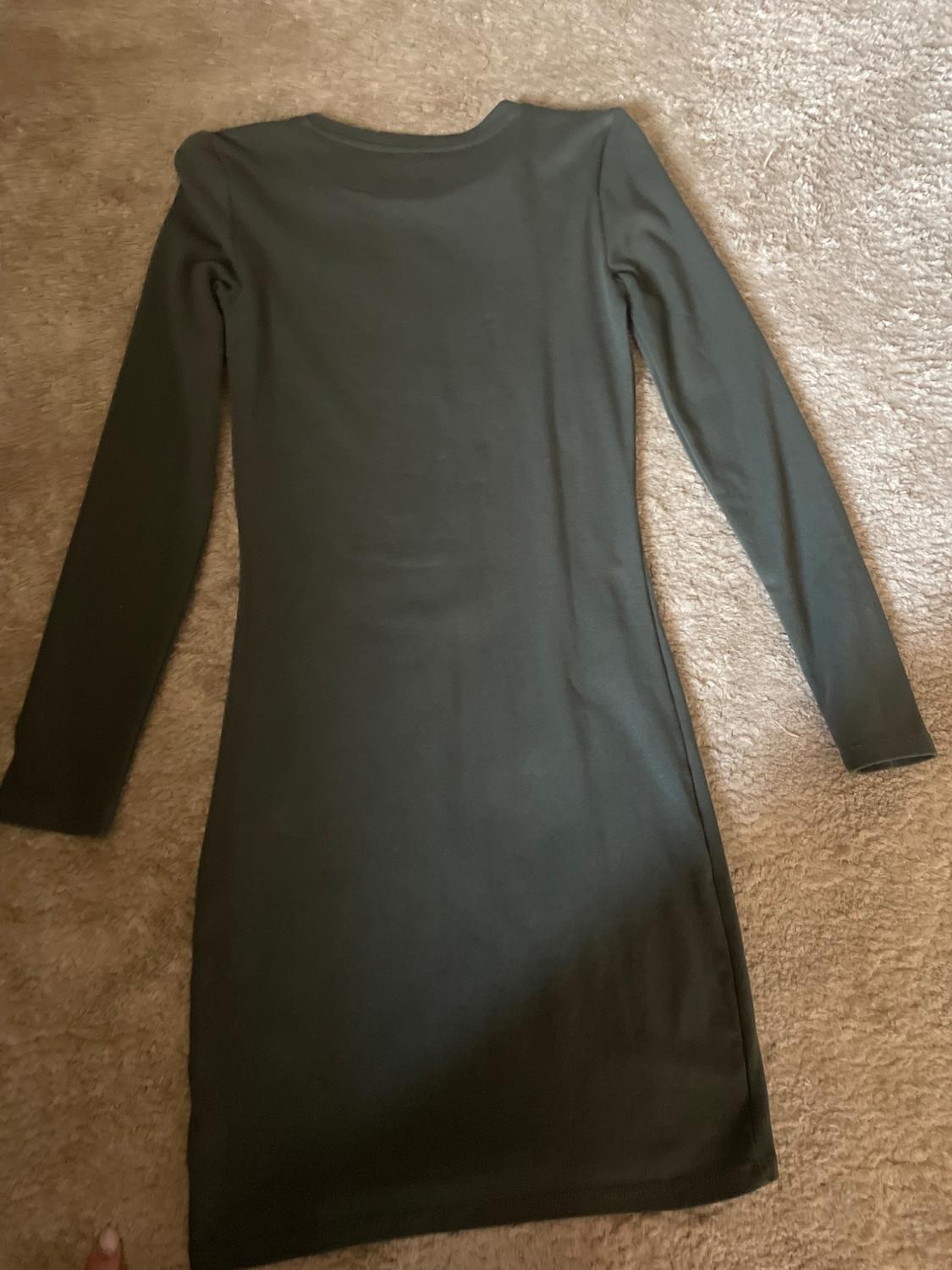 Rear view of a long-sleeved black dress.