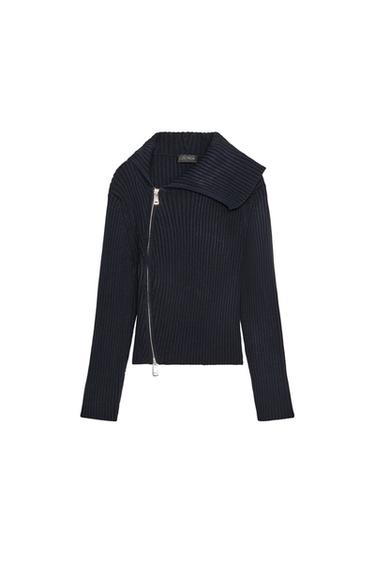 Front view of a navy blue ribbed knit jacket, lapel collar, long sleeves, and a diagonal metal zip.