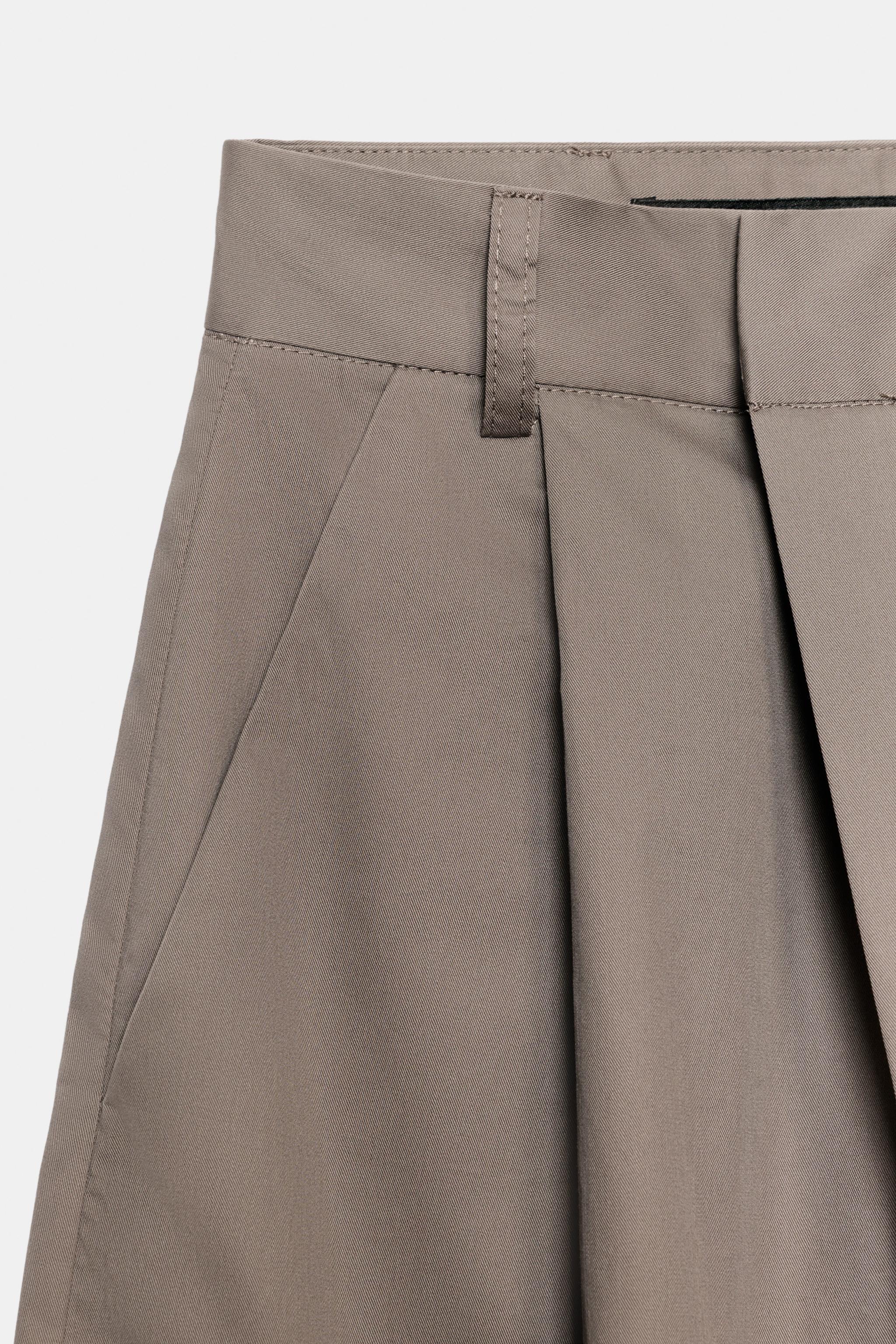 ASYMMETRIC WAIST PLEATED TROUSERS
