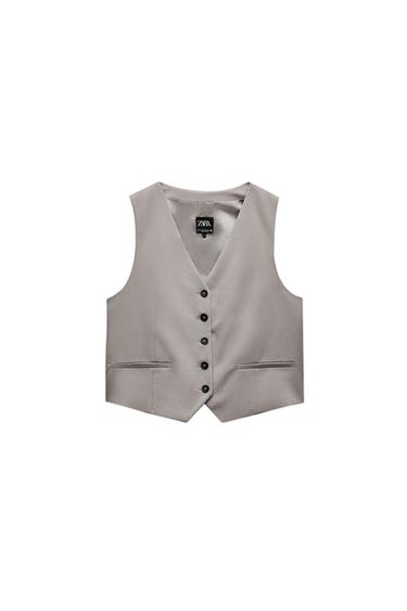 Front view of a grey waistcoat with black buttons and front pockets.