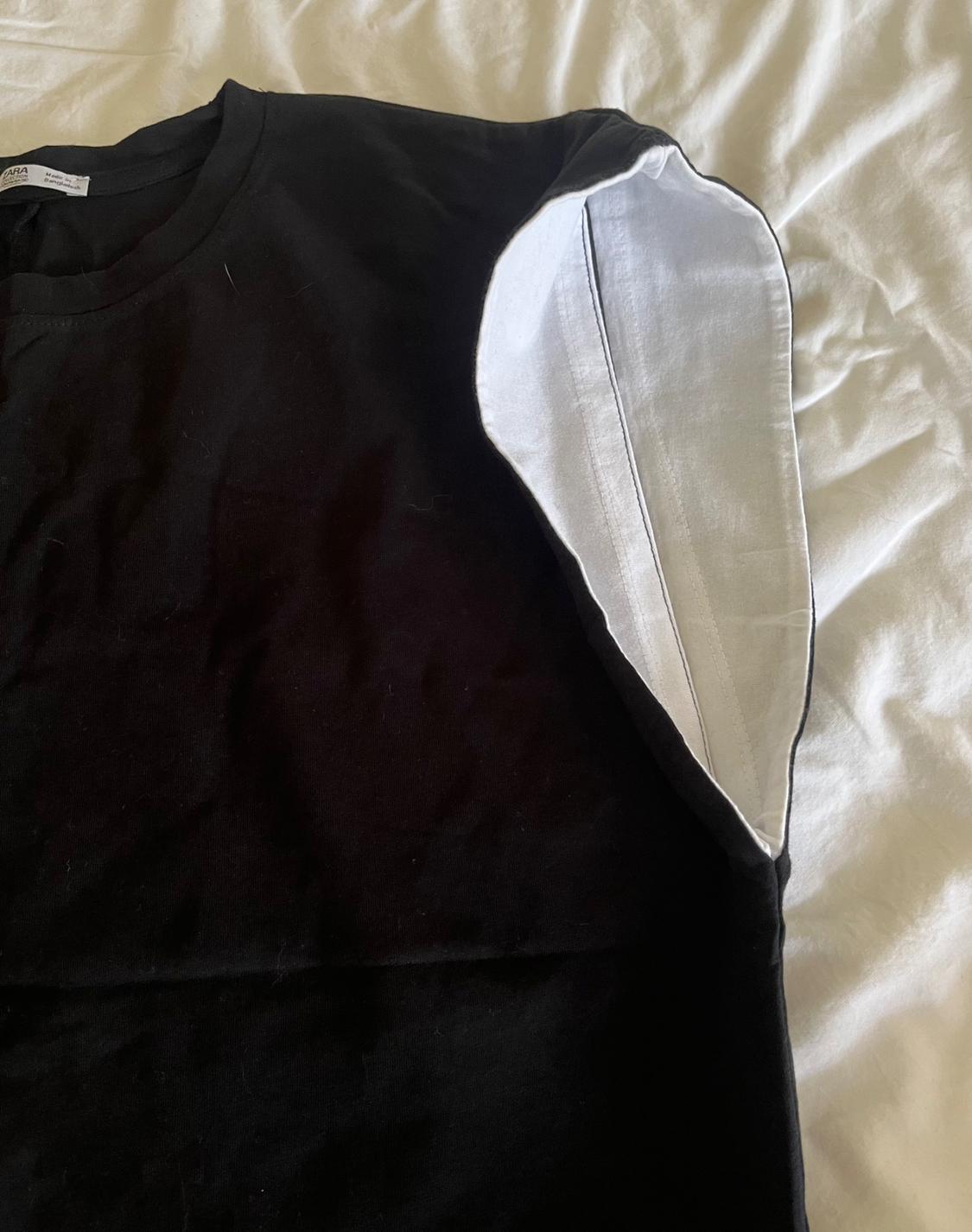 BLACK TSHIRT WITH BATWING LIKE SLEEVES AND CONTRAST LINING. CURVED HEM. - Image 5
