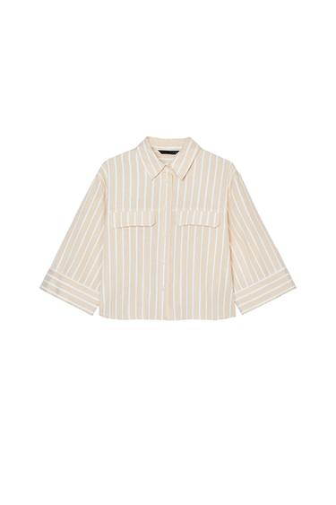 Front view of a beige striped shirt with front pockets and long sleeves.