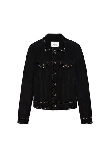 Black jacket with studs on the collar, pockets, cuffs and hem. Front button fastening. Zara label inside. White background.