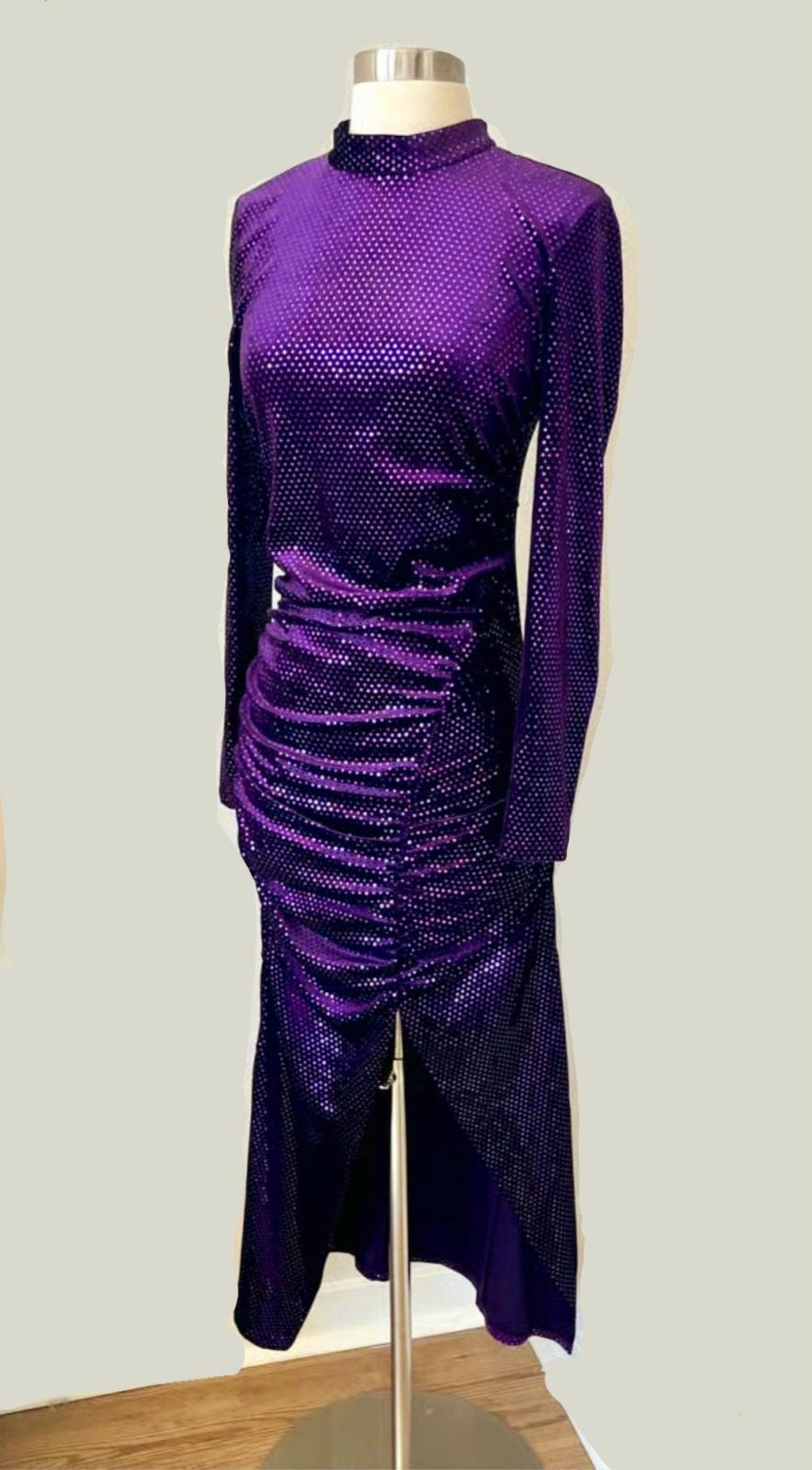 Bright purple dress with a high neck and long sleeves on a mannequin. Fitted design with ruching at the waist and an asymmetric skirt.