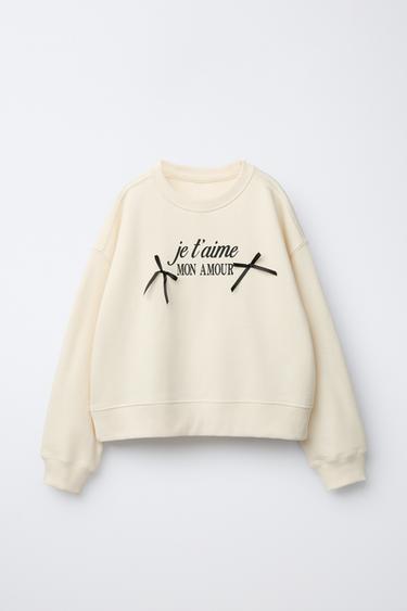 SUDADERA TEXTO Y LACITOS - Blanco roto de Zara - Imagen 0