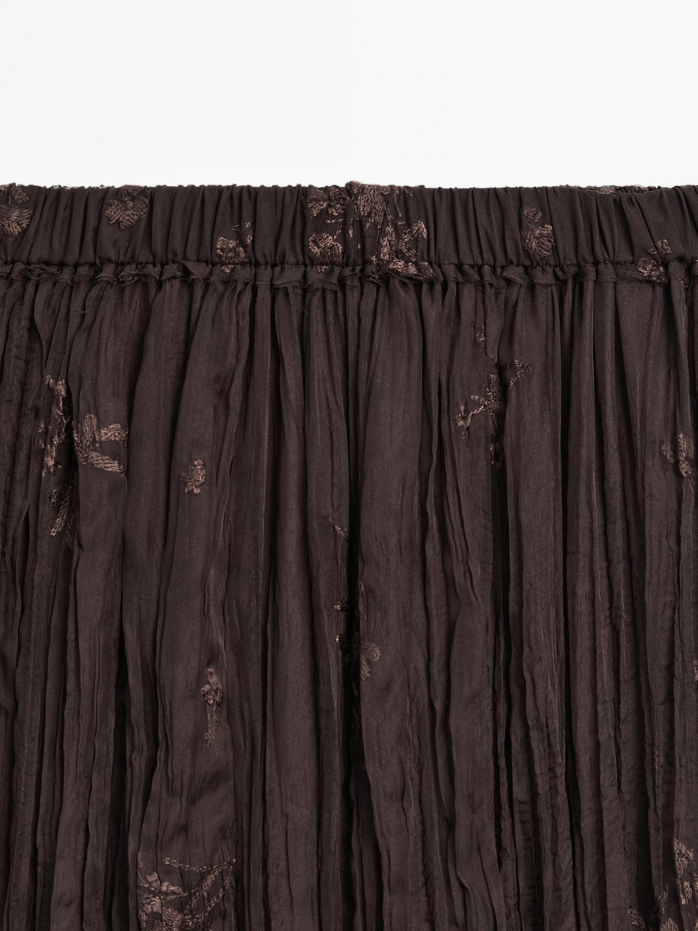 Long pleated skirt with embroidered detail