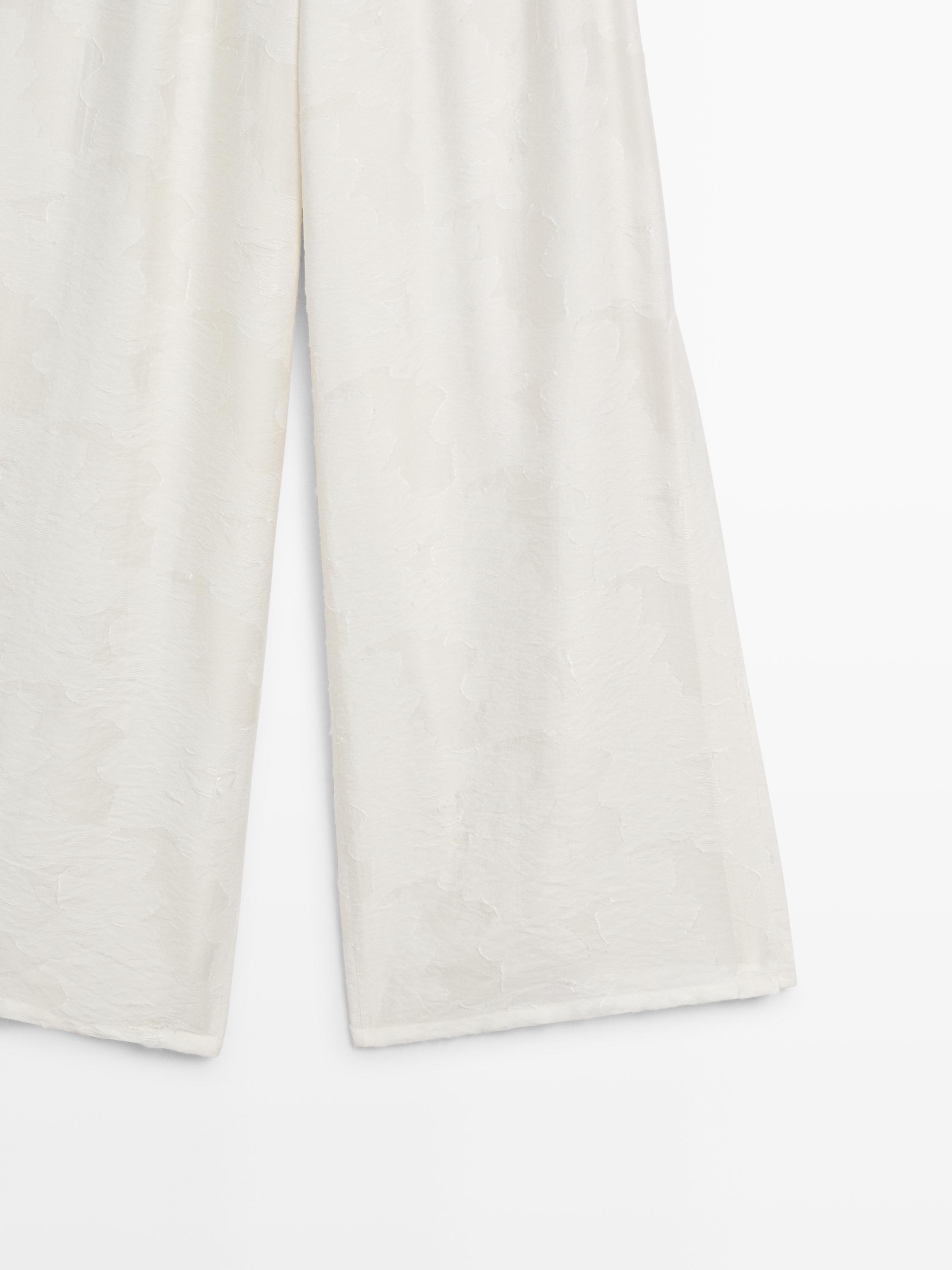 Flowing stretch trousers with fabric detail