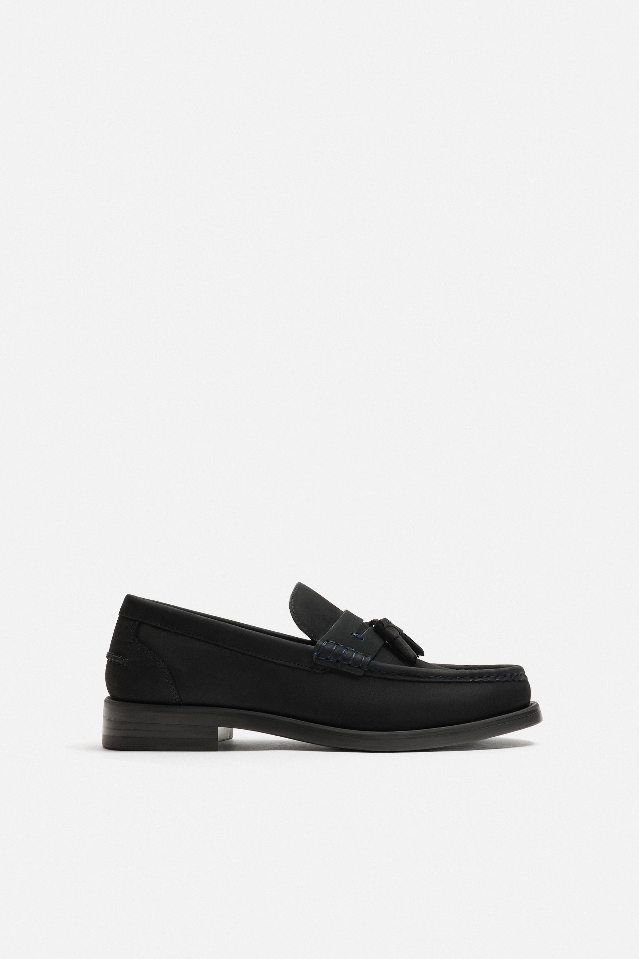 MOCASSINS EN CUIR À POMPONS