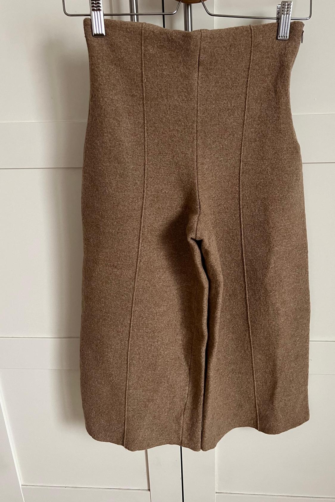 Rear view of brown skirt with vertical seams.