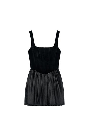 Front view of a sleeveless black dress with a square neckline and pleated skirt.