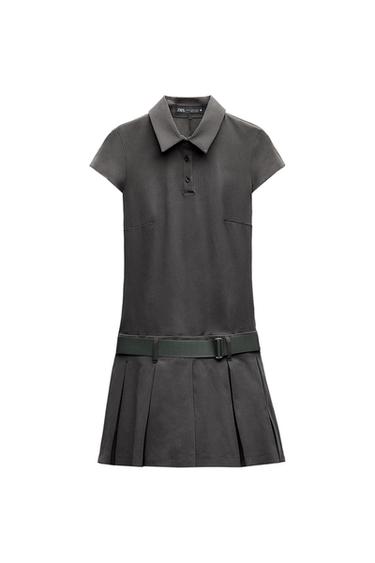 Dark grey short-sleeved polo dress on a white background. Detail of collar with buttons, belt and pleated skirt. ZARA label.
