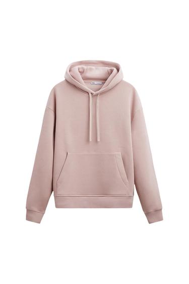 Light pink hooded sweatshirt with drawstring and front kangaroo pocket on a white background. ZARA label on the neck.