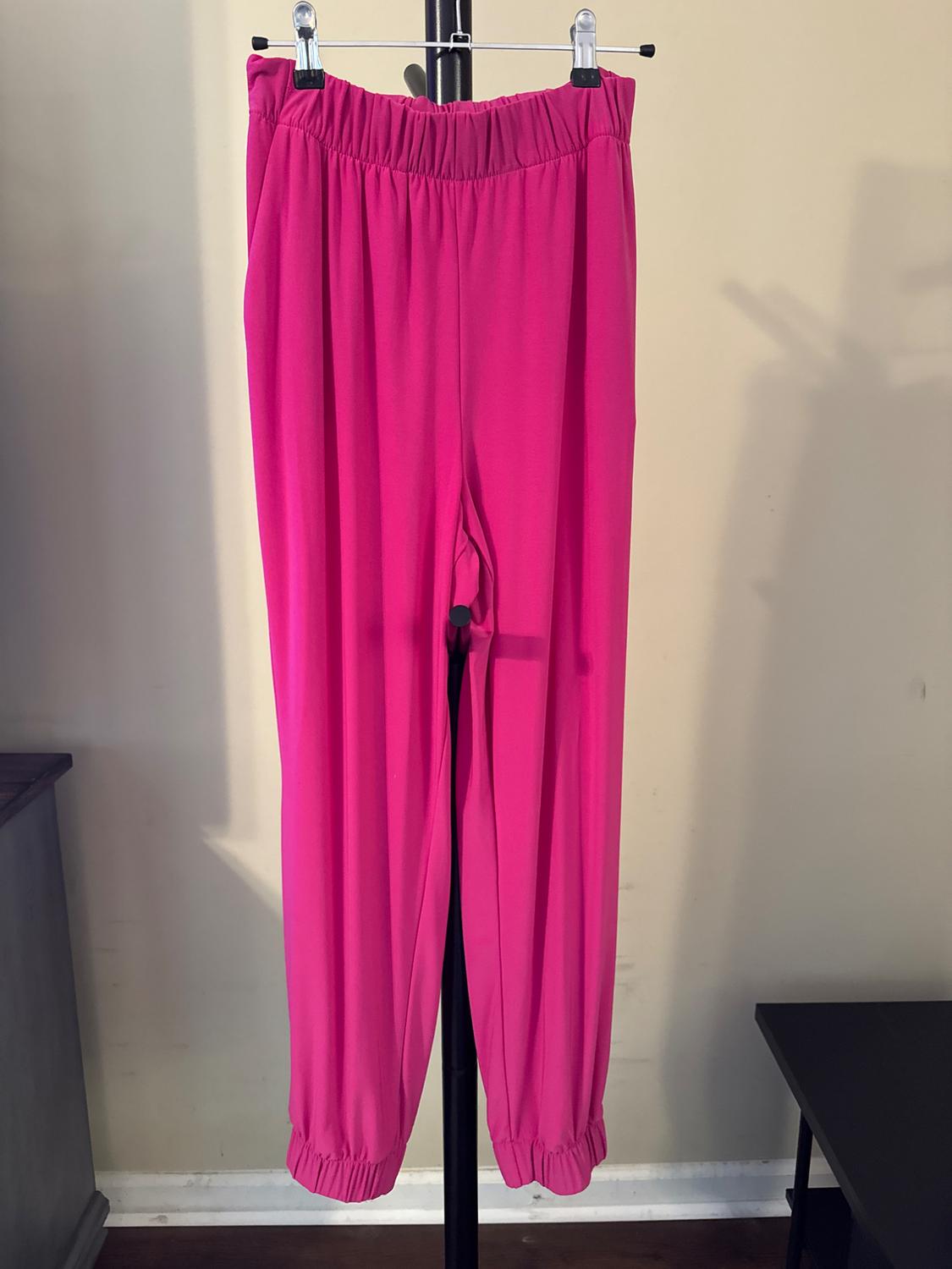 Front view of fuchsia pants with elastic waistband and cuffed ankles.