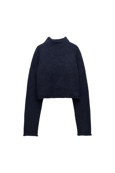 Navy blue knitted high-neck jumper with long sleeves on a white background.
