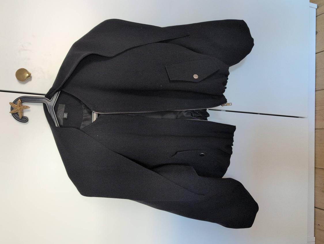 Black long-sleeved jacket with a zip and pockets, hanging on a hanger against a white background with a starfish zip pull.