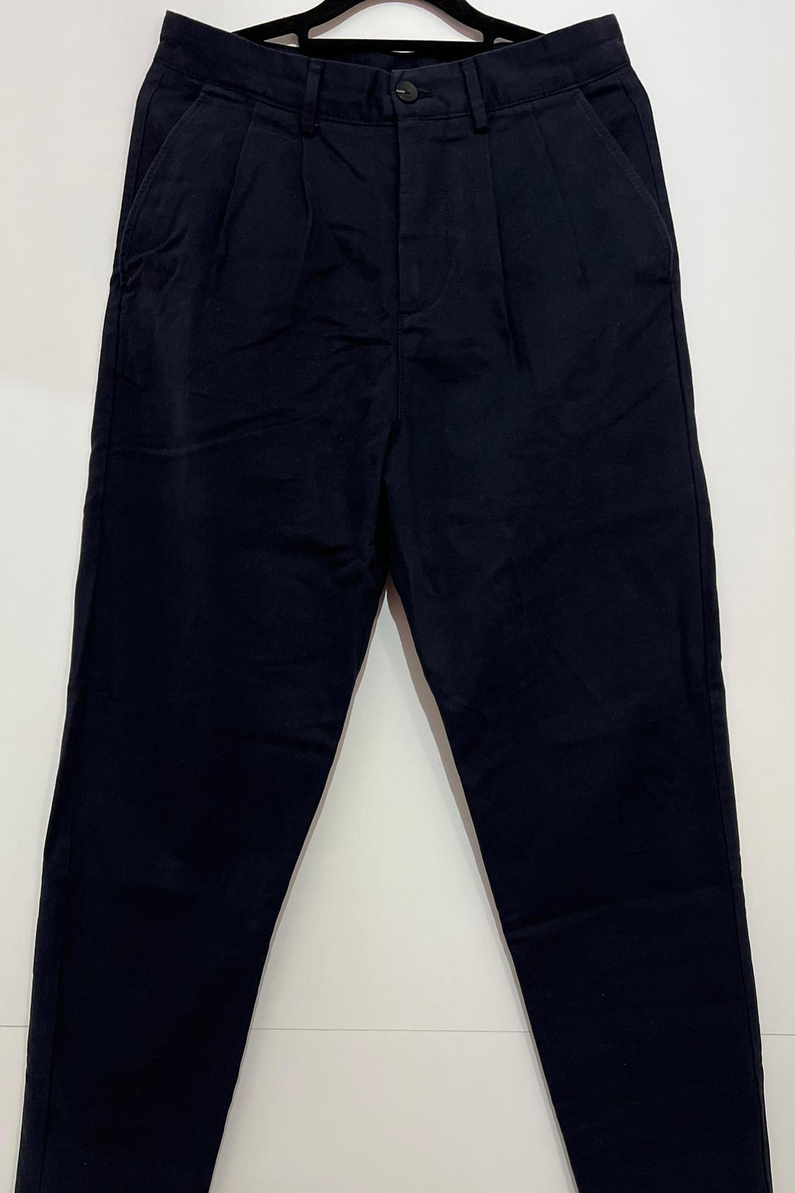 Front view of black trousers with side pockets and button fastening.