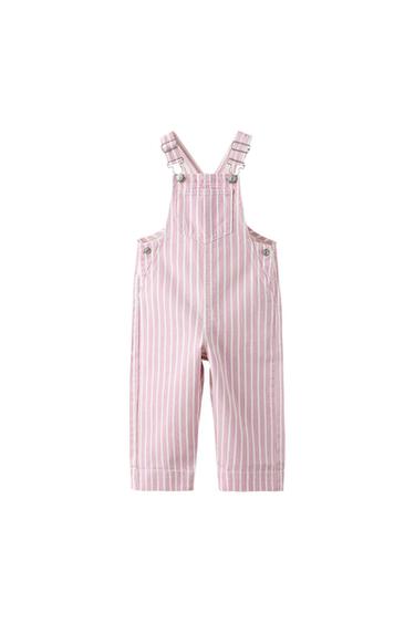 Pink and white vertical striped dungarees with a front pocket and straps with metal clasps on a white background.