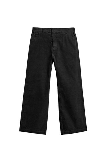 Front view of black flare trousers with front and back patch pockets, zip and button fastening.