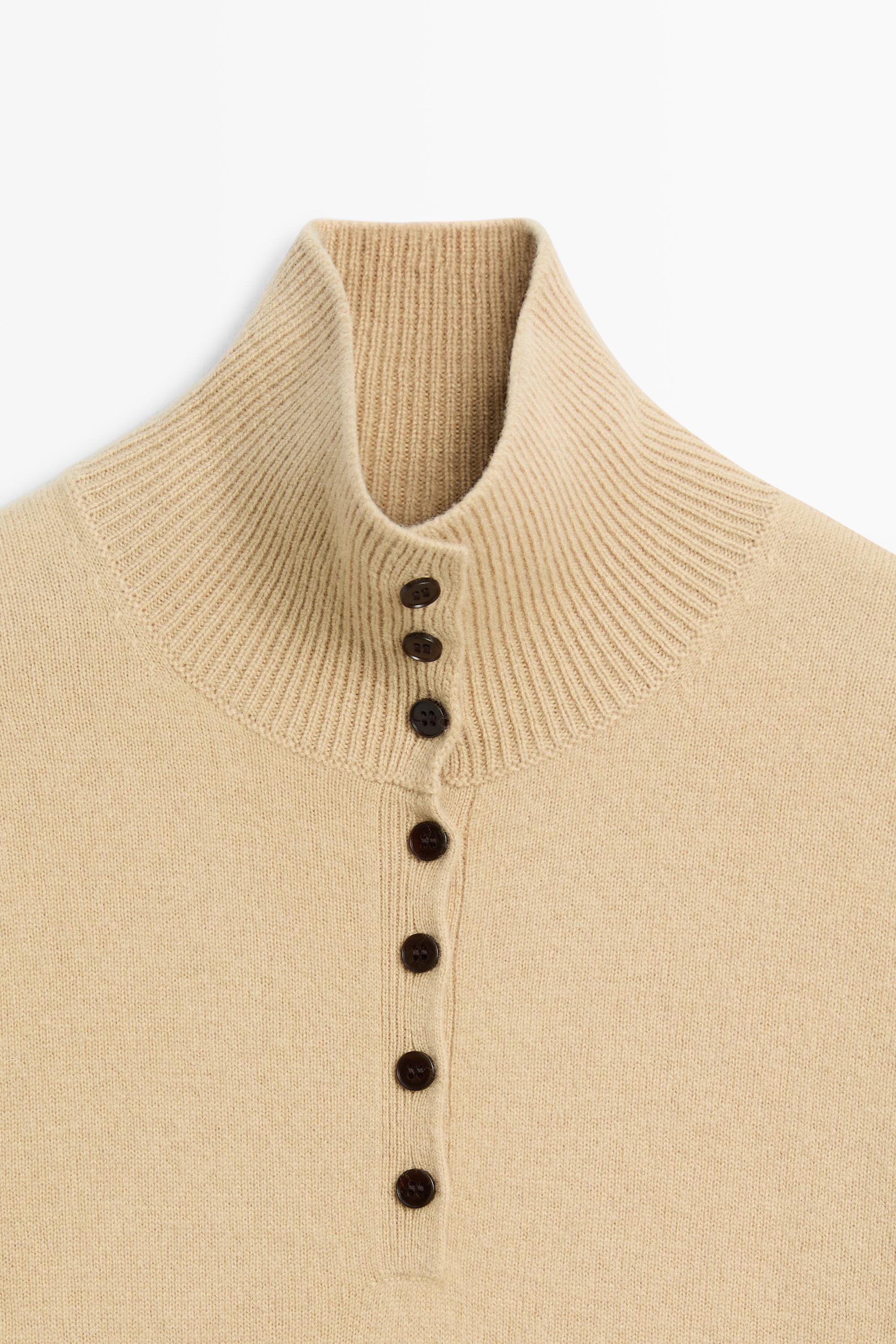 High neck knit sweater with button detail