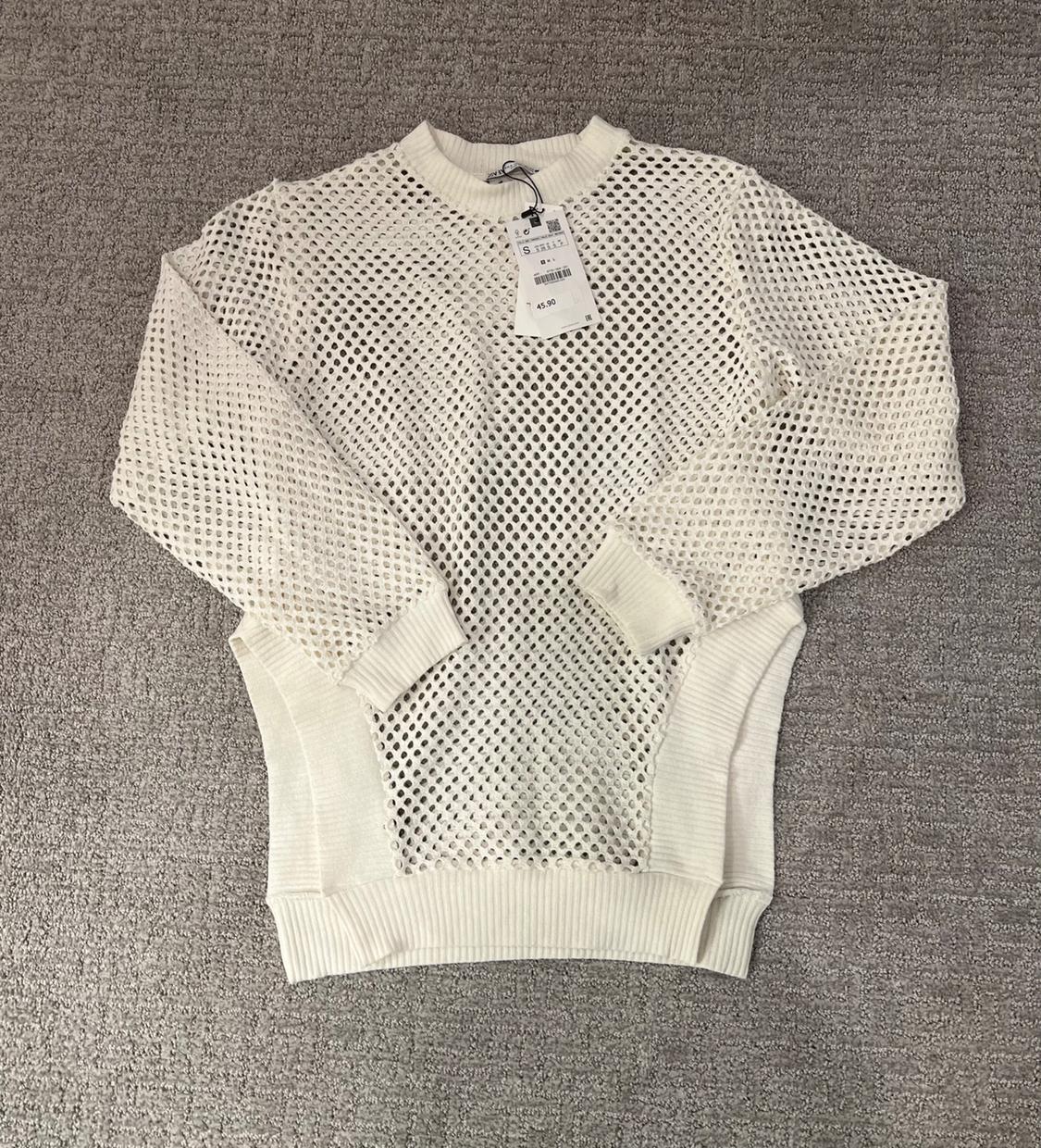 Front view of a white mesh crew neck, long-sleeved sweater.
