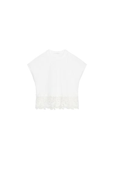 Front view of a white t-shirt with decorative lace trim on the hem.