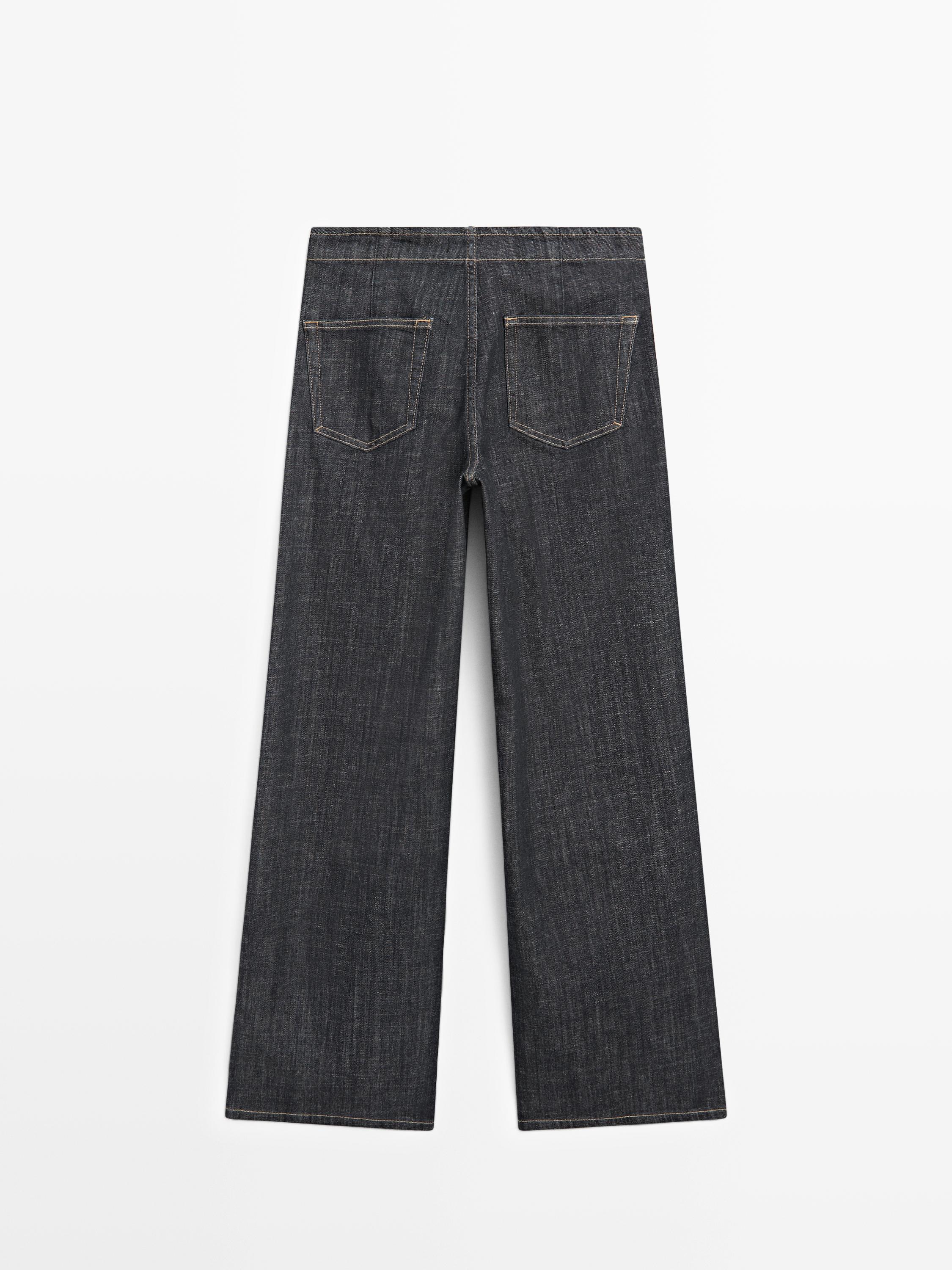 High-waist wide-leg jeans with chains