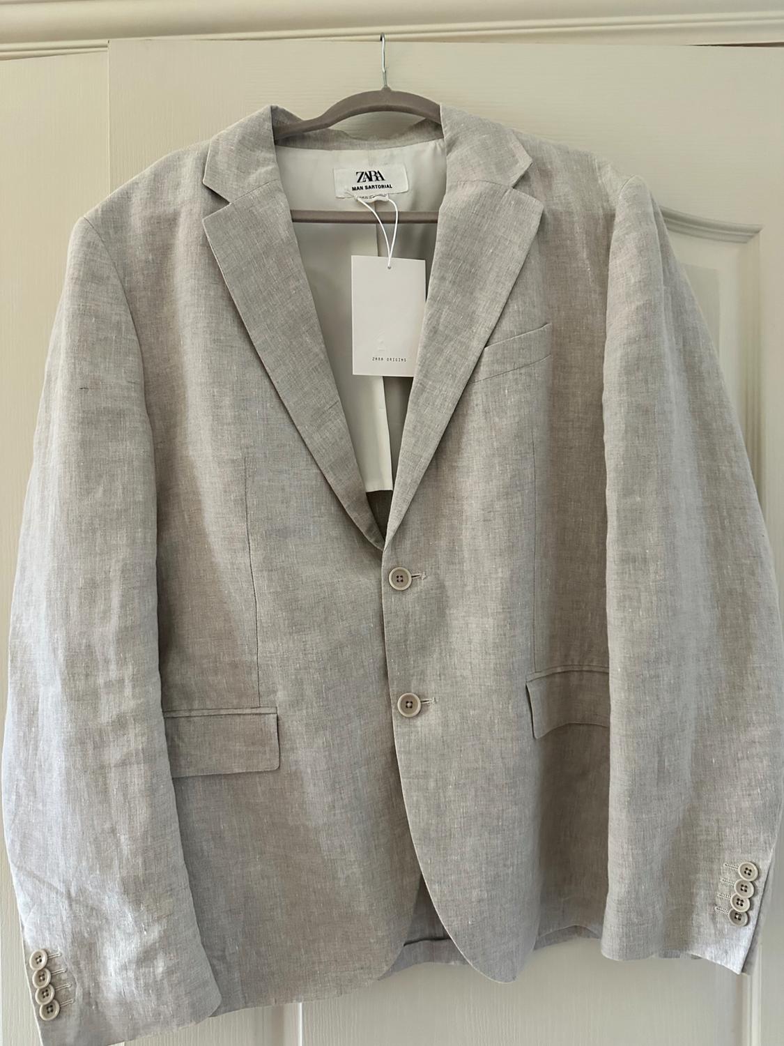 Americana in beige by zara Man Sartorial with the zara Origins tag, hanging on a hanger.