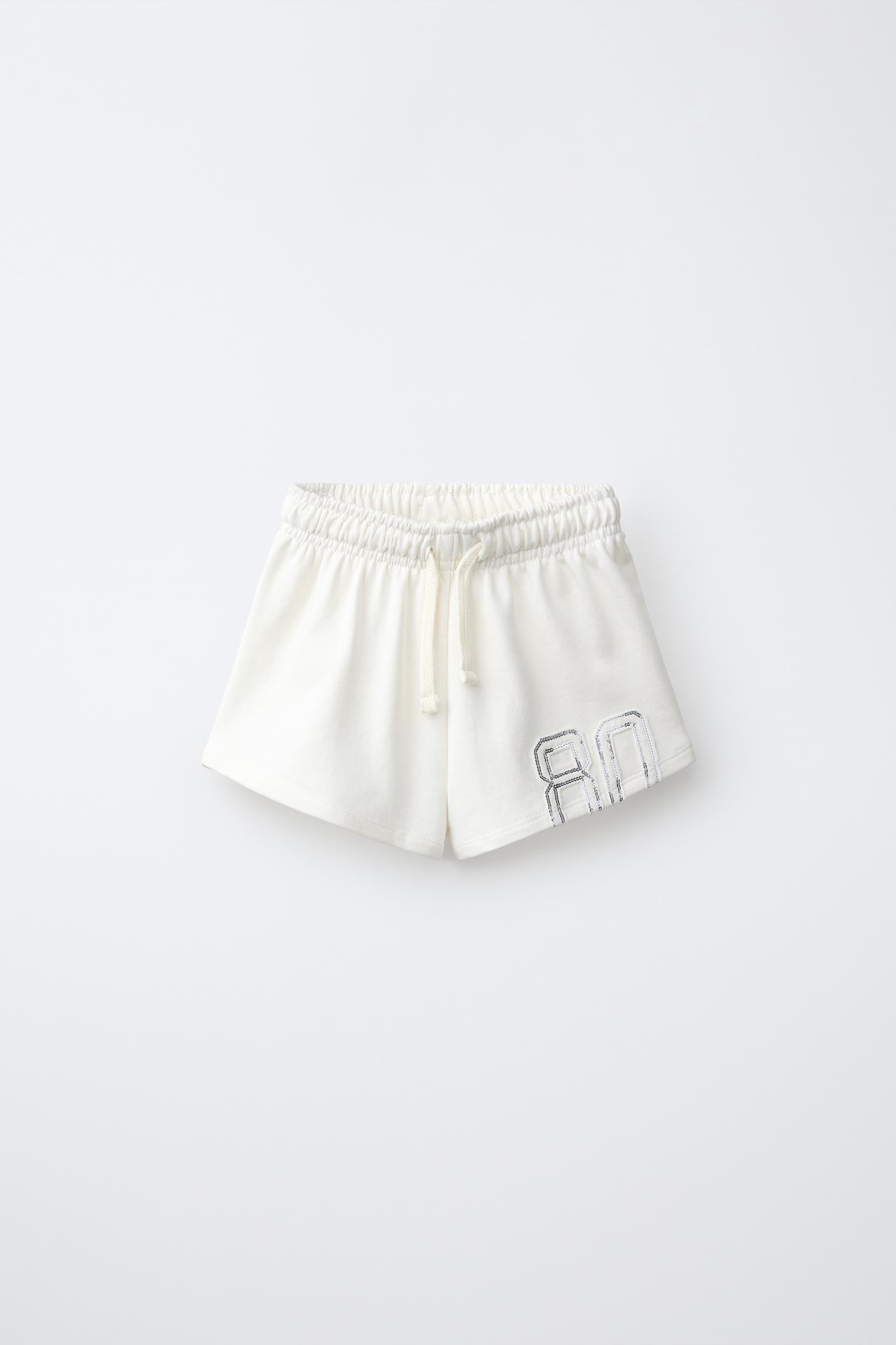 SEQUIN NUMBER PATCH SHORTS — Ecru