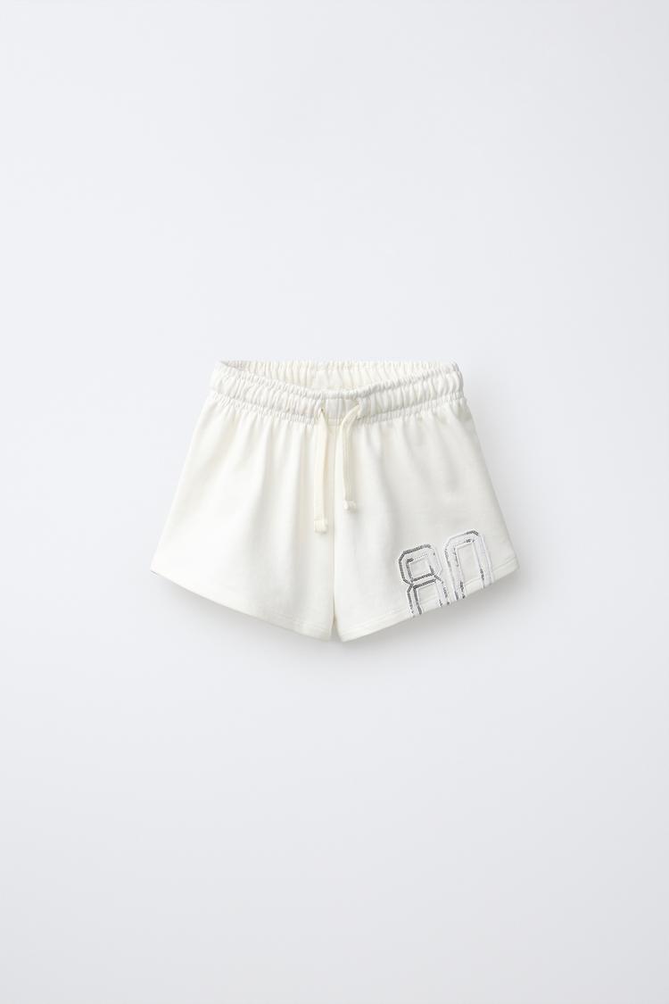 SEQUIN NUMBER PATCH SHORTS — Ecru