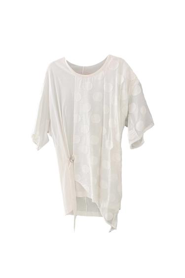 White short-sleeve t-shirt with an embossed polka dot design and a side bow detail, on a white background.