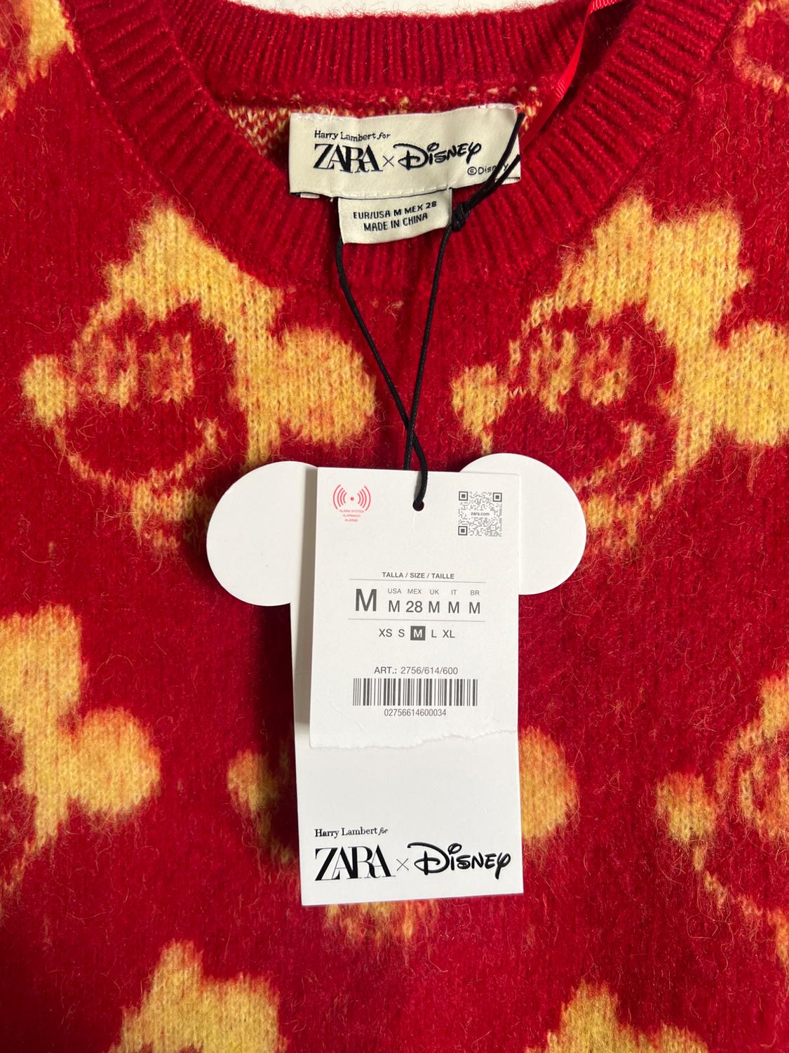 Red jumper tag with yellow print, Harry Lambert for Zara x Disney collaboration. Size M, made in China. Mickey-shaped tag.