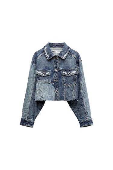 Front view of a short blue denim jacket with front pockets and metal buttons.