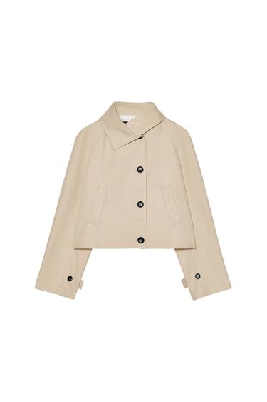 Front view of beige jacket with black buttons and side pockets.
