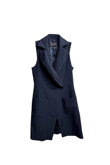 Black sleeveless vest with wide lapels and large pockets. Visible interior tag with "ZARA BASIC" text. White background.