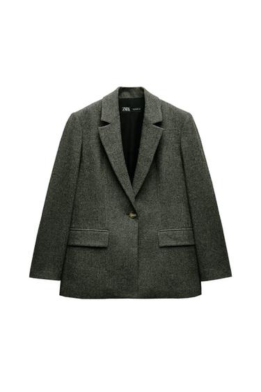Front view of gray jacket with lapel and side pockets.