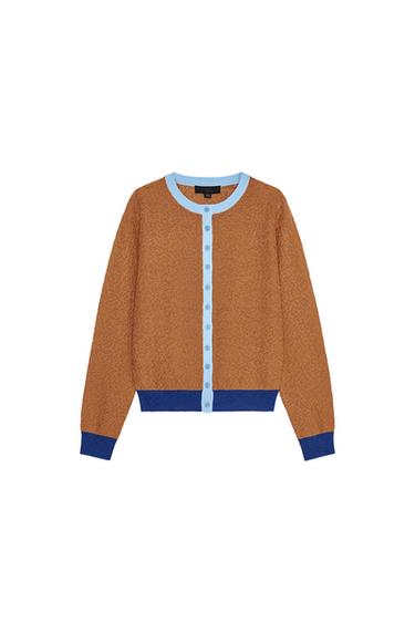 Textured brown knitted cardigan on a white background. It features a round neck, light blue buttons and trim, and dark blue cuffs and hem.