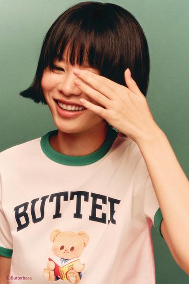 パイピングディテール BUTTERBEAR © TシャツエクリュZaraのパイピングディテール BUTTERBEAR © Tシャツ - エクリュ