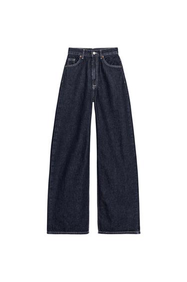 Front view of indigo high-waisted, wide-leg, extra-long jeans with five pockets and a front zipper and button closure.