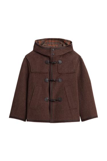 Front view of a taupe duffle coat with a hood, toggle fastening, and jetted pockets. Contrast checked interior.