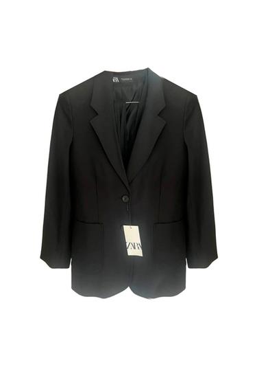 Black suit jacket with classic lapels and one button. Hanging tag with the text "ZARA". White background.