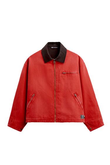 Front view of a red jacket with a zip fastening, brown collar, and side pockets with zips.