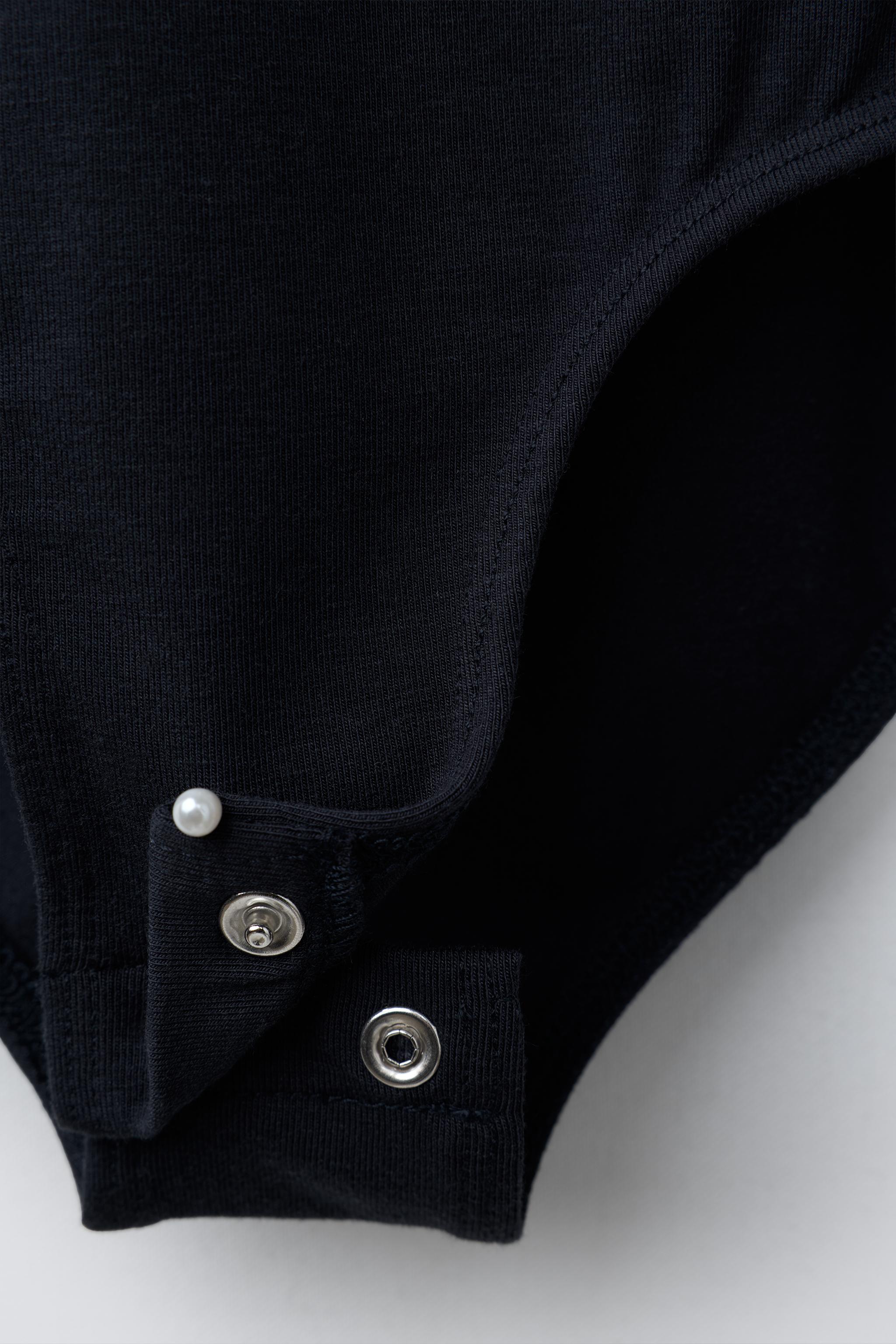 RUFFLED BODYSUIT WITH STUDS AND MODAL