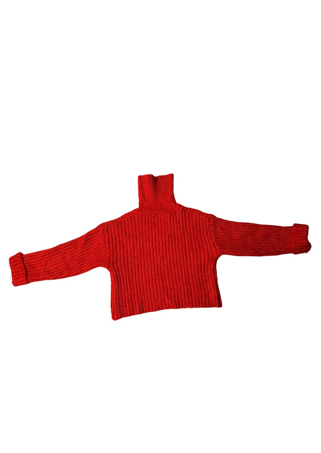 Chunky red knitted jumper with a high neck and long sleeves extended over a white background.