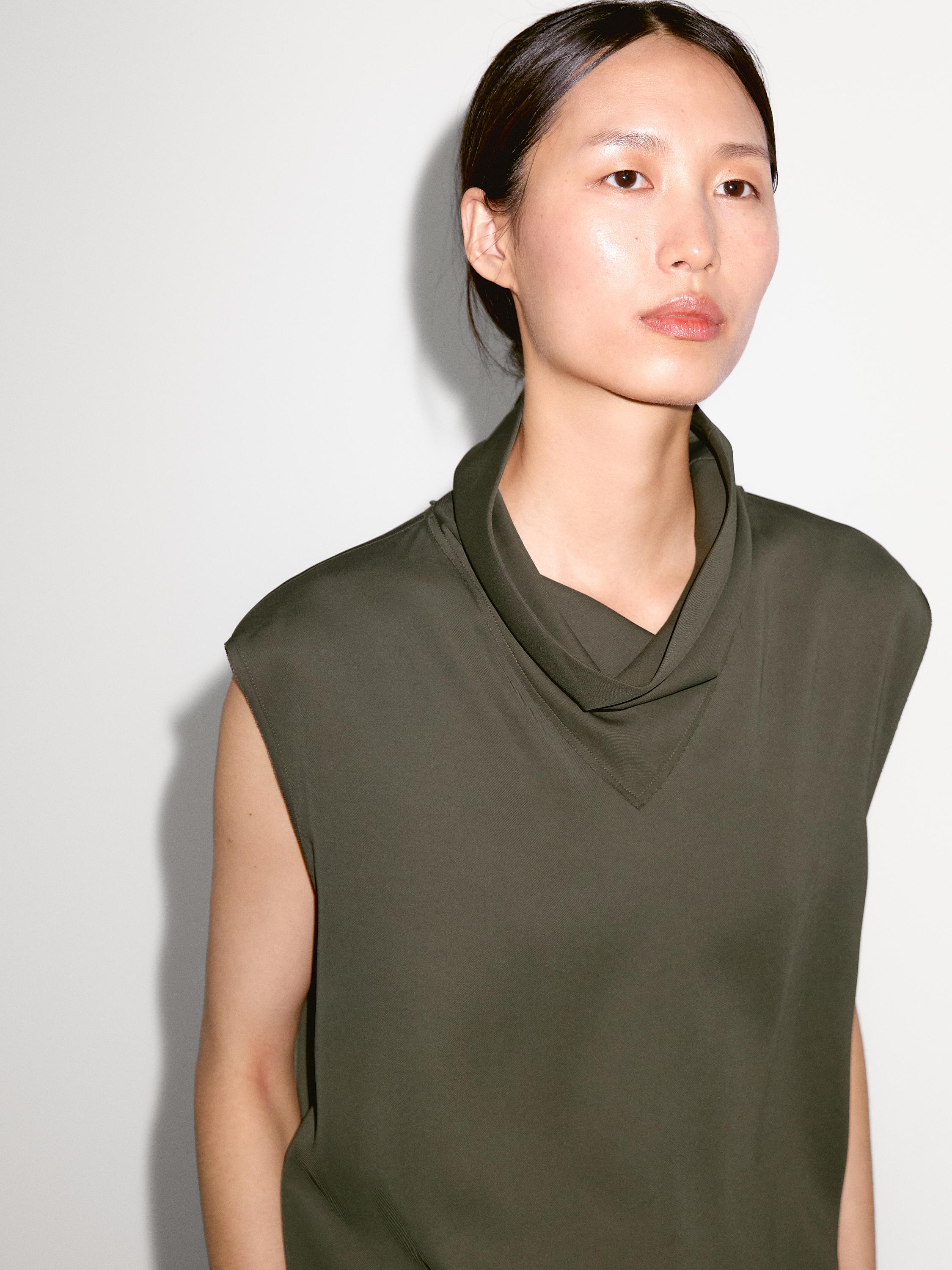 Flowing blouse with draped neck detail