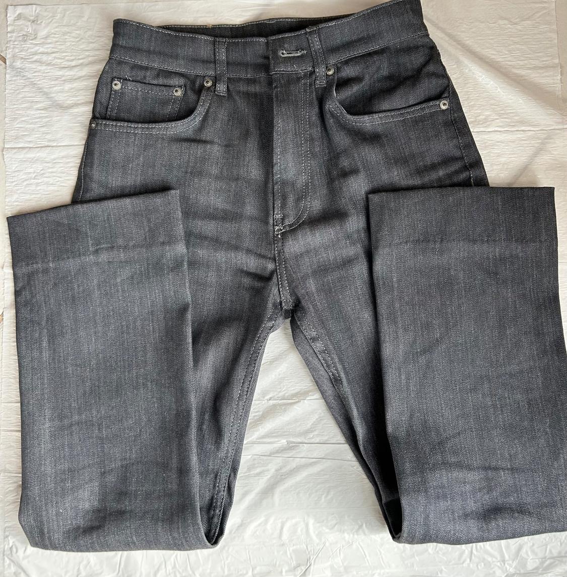 Front view of grey jeans with front pockets and belt loops.