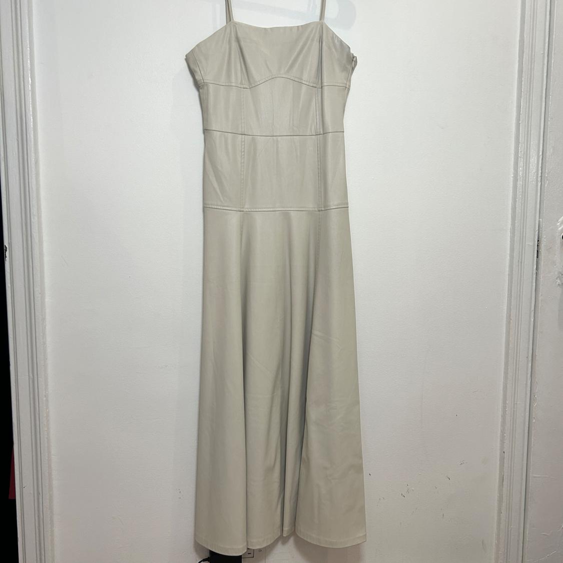 Straight neck midi dress with spaghetti straps. Hidden in-seam zipper closure.