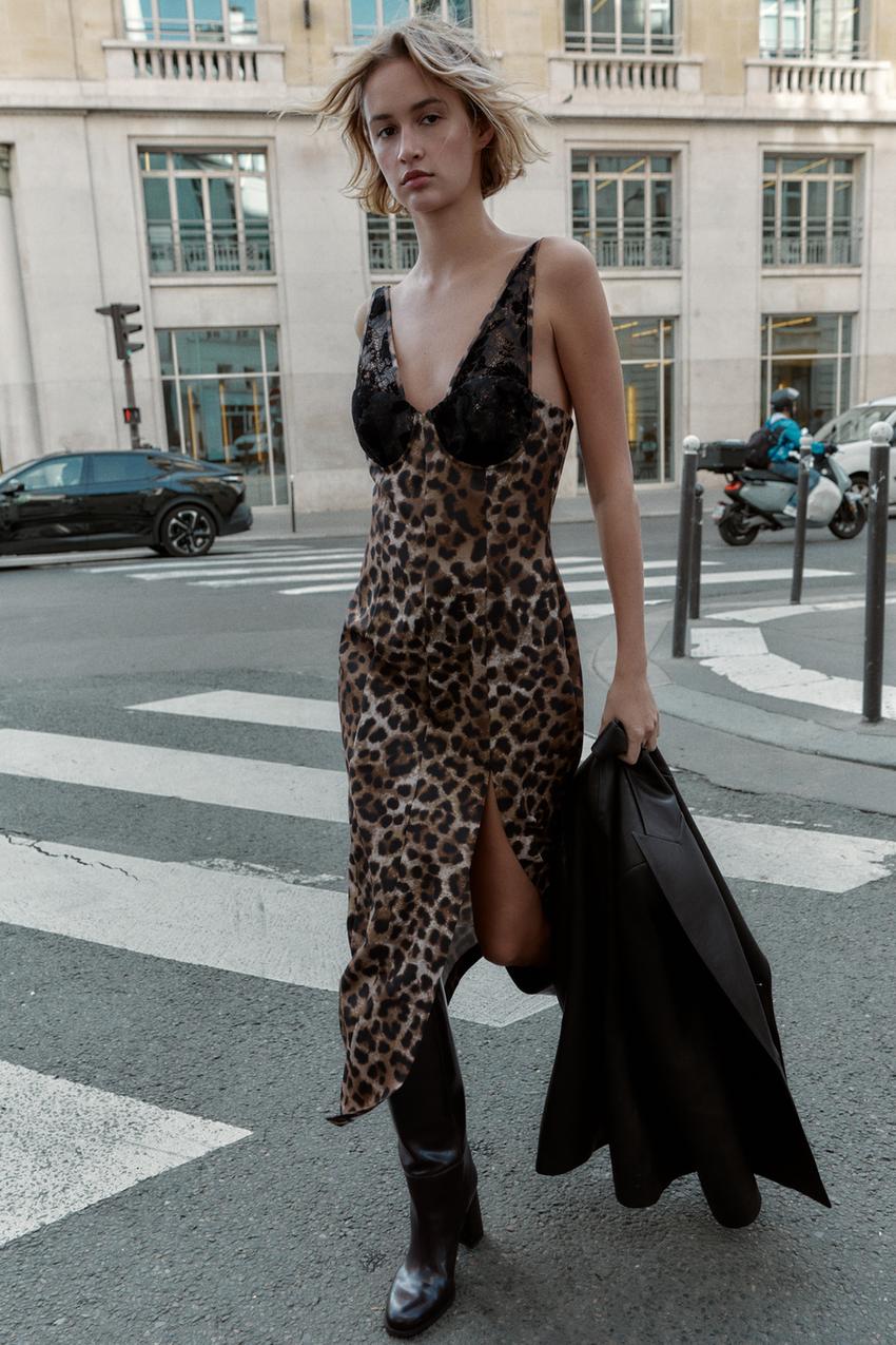 Animal print midi dress set with black lace, spaghetti straps, and a front slit, paired with black high-heeled boots.