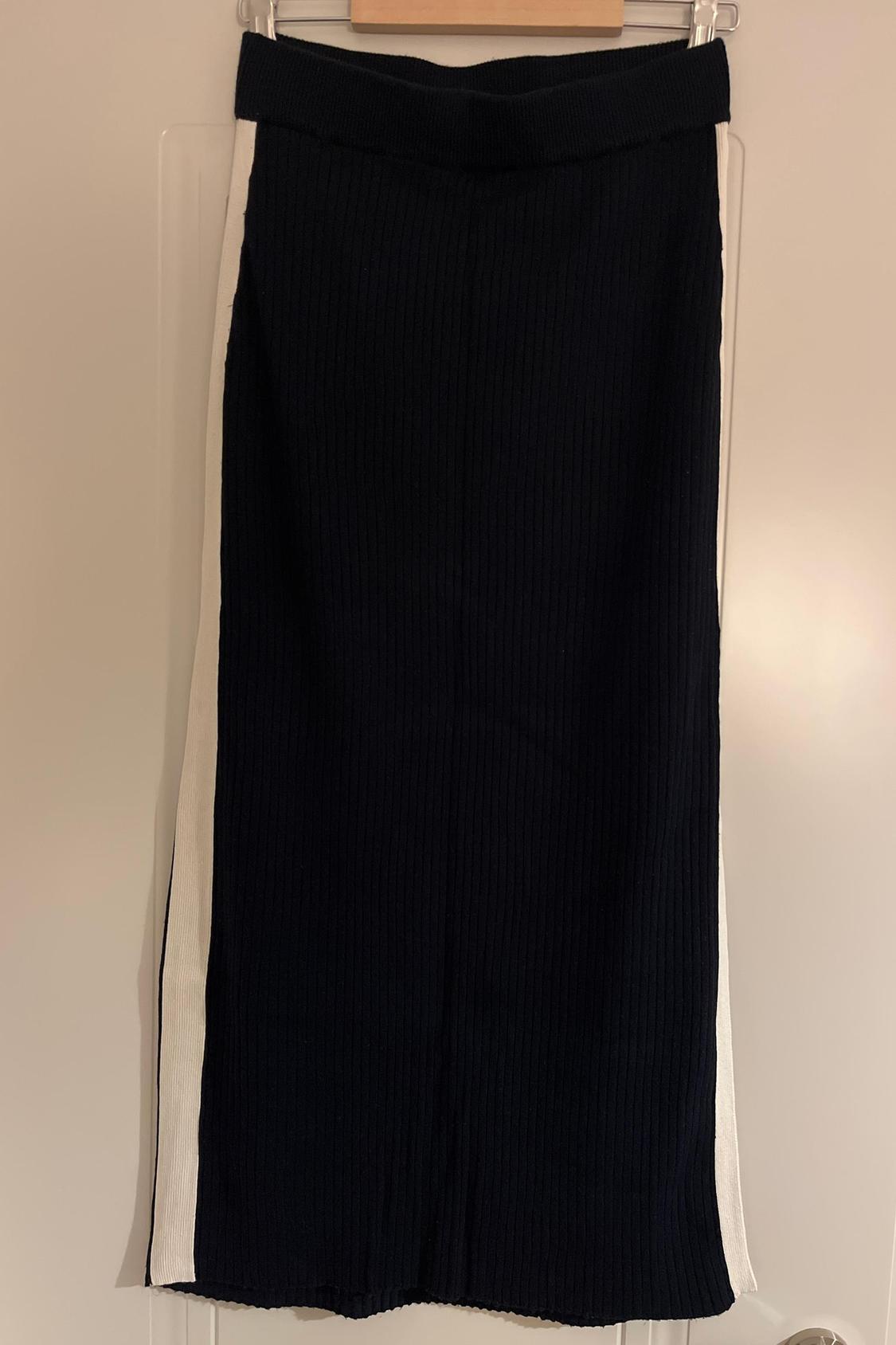 Front view of black skirt with white side stripes.