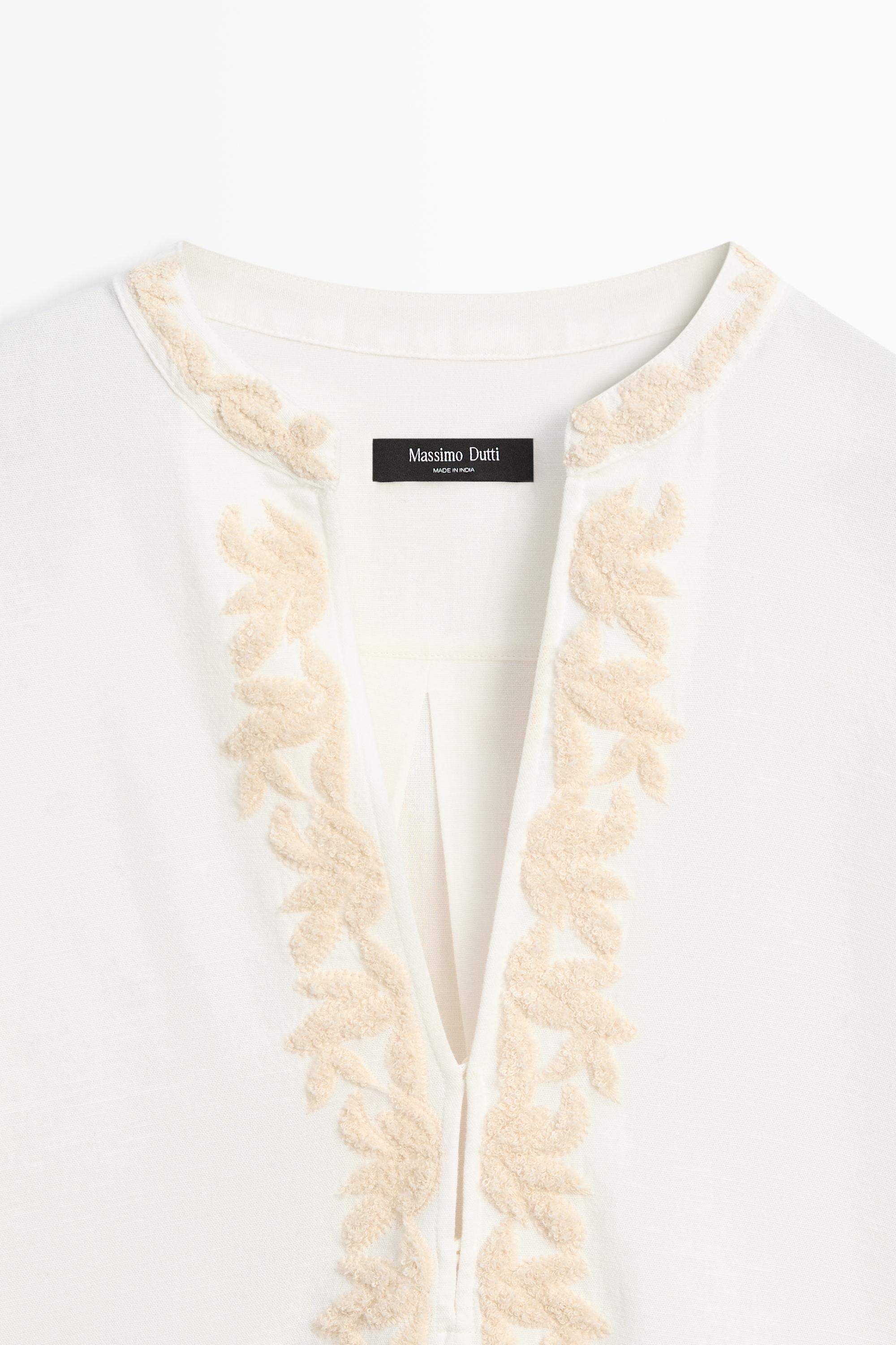 Flowing oversize blouse with stand collar and embroidery